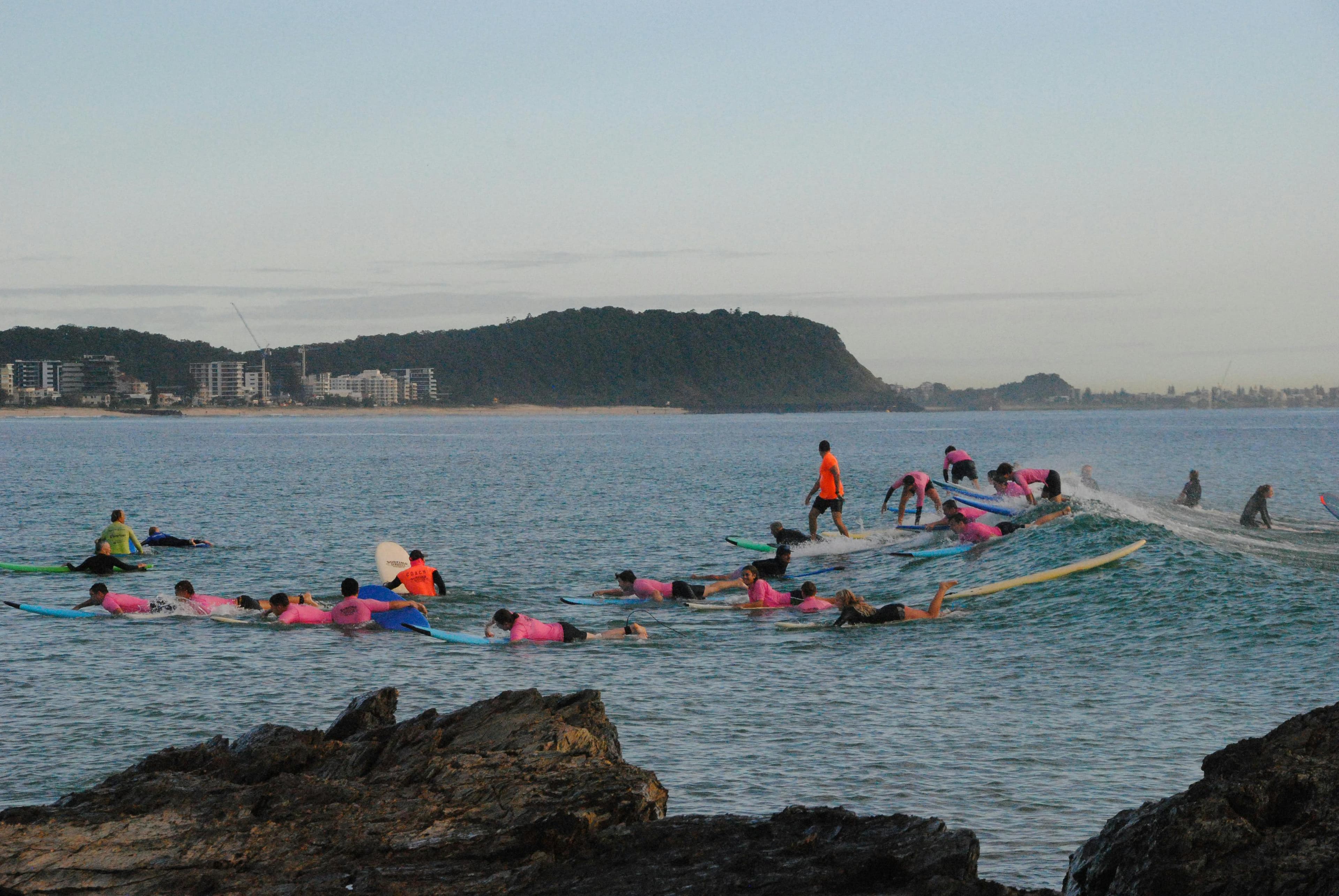 Surfers riding waves